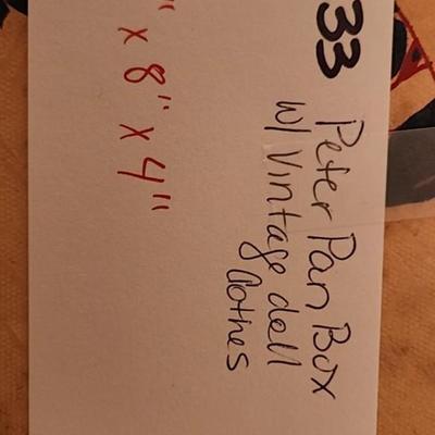 Peter Pan Storage box with vintage doll clothes.