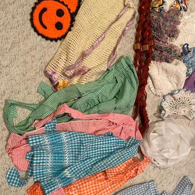 Vintage aprons, one macramé, plant hanger, and doilies