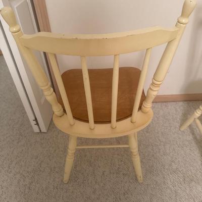 2 cream colored wooden chairs