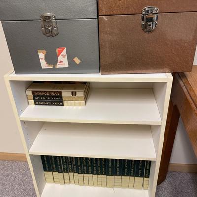 Small white bookcase with two metal organizers and world book encyclopedia