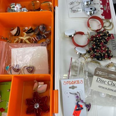 Multiple earring sets in Tupperware container