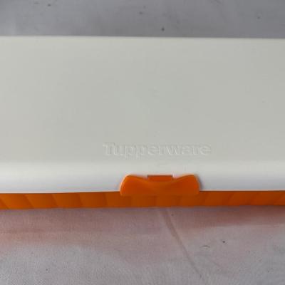 Multiple earring sets in Tupperware container