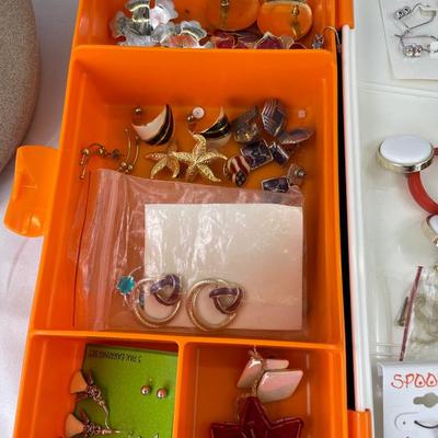 Multiple earring sets in Tupperware container