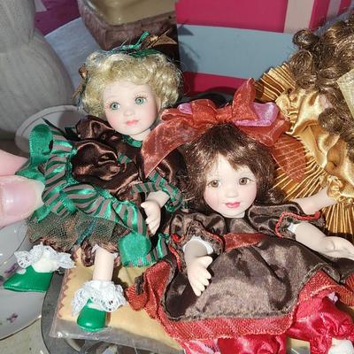 3 mini dolls sitting in silver plated dish