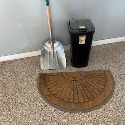 Shovel, rug and garbage can