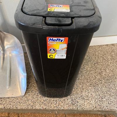 Shovel, rug and garbage can