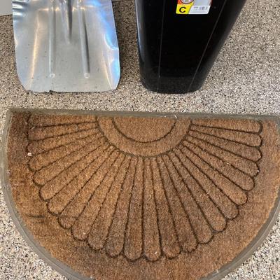 Shovel, rug and garbage can