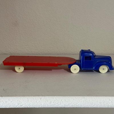 1937 AUBURN RUBBER CABOVER STAKE TRUCK & PLASTIC TRUCK W/TRAILER