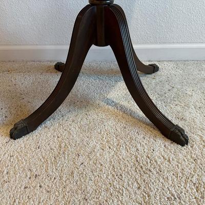 ROUND MAHOGANY SIDE TABLE W/BRASS CLAW FEET AND A CERAMIC POODLE