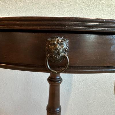ROUND MAHOGANY SIDE TABLE W/BRASS CLAW FEET AND A CERAMIC POODLE