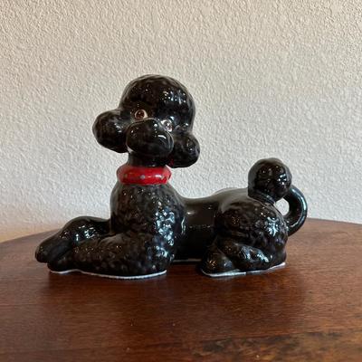 ROUND MAHOGANY SIDE TABLE W/BRASS CLAW FEET AND A CERAMIC POODLE