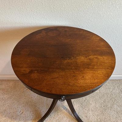 ROUND MAHOGANY SIDE TABLE W/BRASS CLAW FEET AND A CERAMIC POODLE