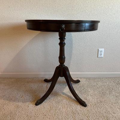ROUND MAHOGANY SIDE TABLE W/BRASS CLAW FEET AND A CERAMIC POODLE