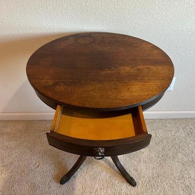 ROUND MAHOGANY SIDE TABLE W/BRASS CLAW FEET AND A CERAMIC POODLE