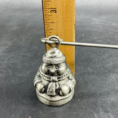 Sale Photo Thumbnail #437: Pewter candle Snuffer, approx. 11” handle.  Snowman is approx. 2” tall. Great condition.