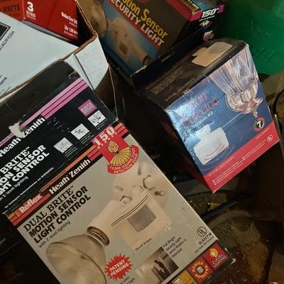 Box of different size lightbulbs includes motion sensor, security lights