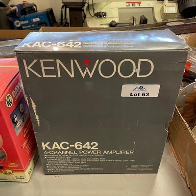Older push button car radio sitting inside this Kenwood box