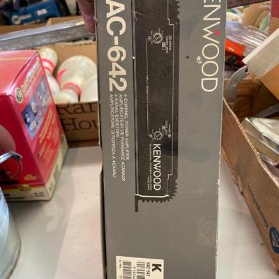 Older push button car radio sitting inside this Kenwood box