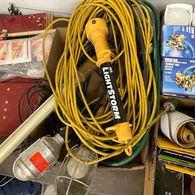Box of various extension cords & 4 shop lights