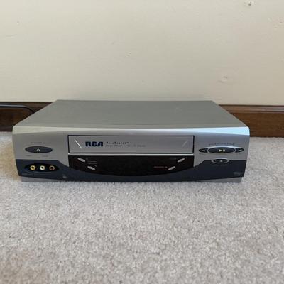 LOT 29B: RCA VCR Model No VR651HF w/ Collection of Disney VHS Tapes