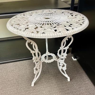 Sale Photo Thumbnail #452: Ornate white aluminum patio table with rose designs. Table is approx. 25" high and 23" across.  In good condition.