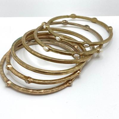 LOT 115: Collection of Gold Tone Bangle Bracelets