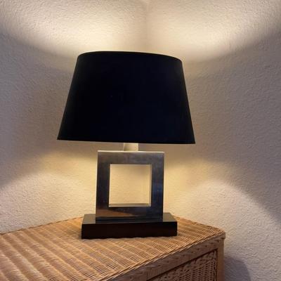 Pair of modern chrome, square bed side lamps with black shades.