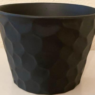Wooden hanging basket, a small black planter with honeycomb design, 2 small metal planters and one taller decorative planter