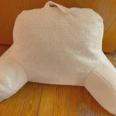 Bring some softness into your bedroom with a super soft husband, a cloth red and white clothes basket and a elegant table