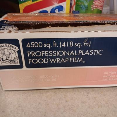CLEANING PRODUCTS, LARGE ROLL OF PLASTIC WRAP AND BROOM WITH DUST PAN