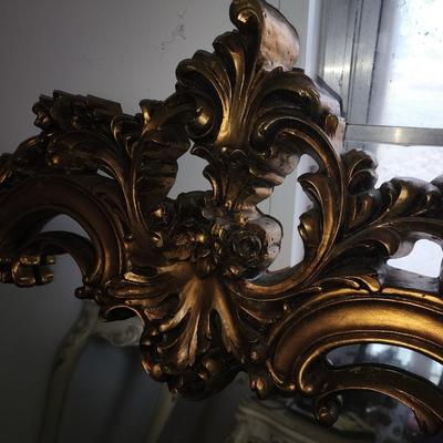 Gold framed mirror.