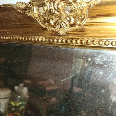 Heavy gold framed mirror.