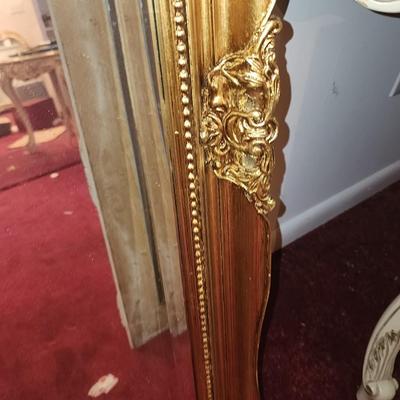 Heavy gold framed mirror.