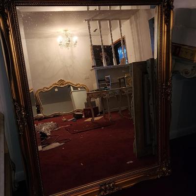 Heavy gold framed mirror.