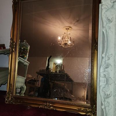 Heavy gold framed mirror.