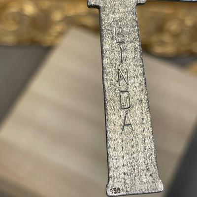 14K and 950 silver Egyptian cartouche spells “Linda”