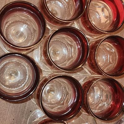 12 Cranberry full size goblets.