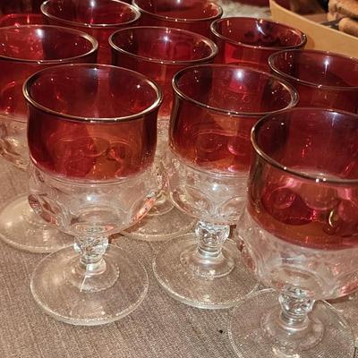 12 Cranberry full size goblets.