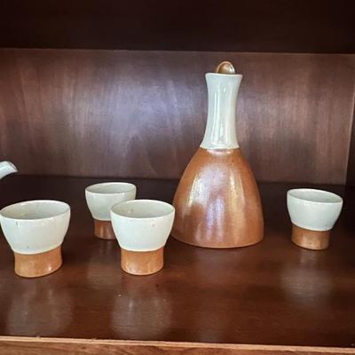 Stoneware decanter, cups and teapot