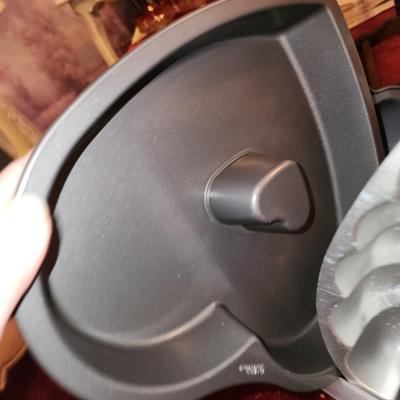 Lot of baking pans. Many shapes. About 15. Total.