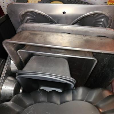 Lot of baking pans. Many shapes. About 15. Total.