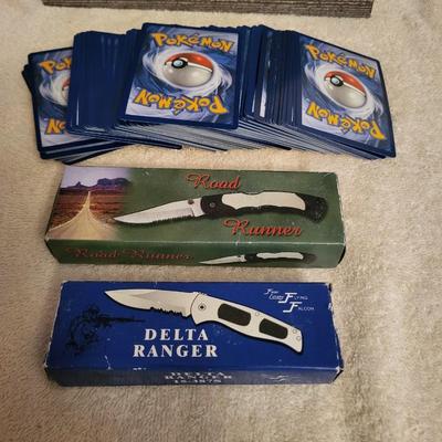 STACK OF NEWER POKEMON CARDS AND 2 NEW POCKET KNIVES