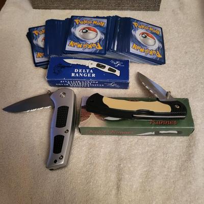 STACK OF NEWER POKEMON CARDS AND 2 NEW POCKET KNIVES