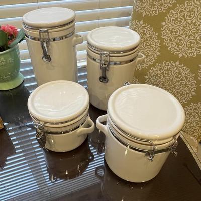 4 white canisters