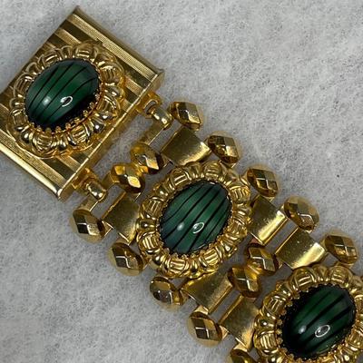 Wide bracelet with green glass cabochons