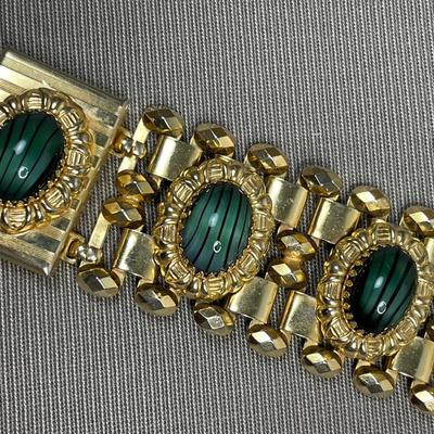 Wide bracelet with green glass cabochons