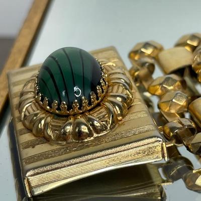 Wide bracelet with green glass cabochons