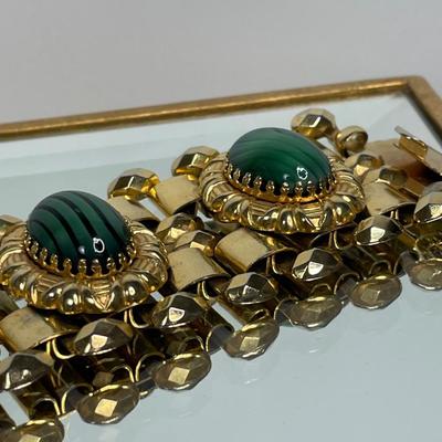 Wide bracelet with green glass cabochons