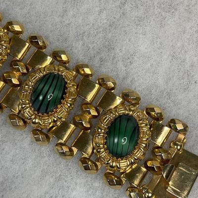 Wide bracelet with green glass cabochons