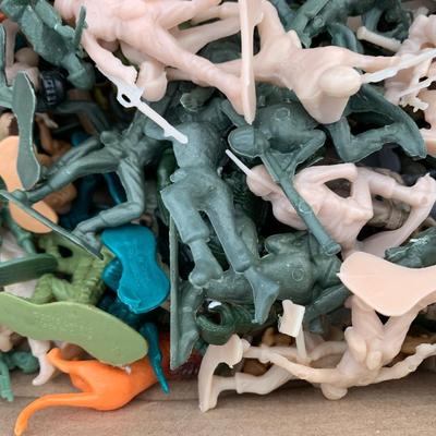 Box full of plastic toy soldiers
